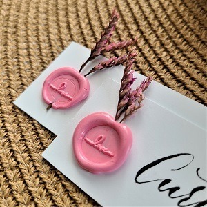 Two wax seals with dried florals on place cards